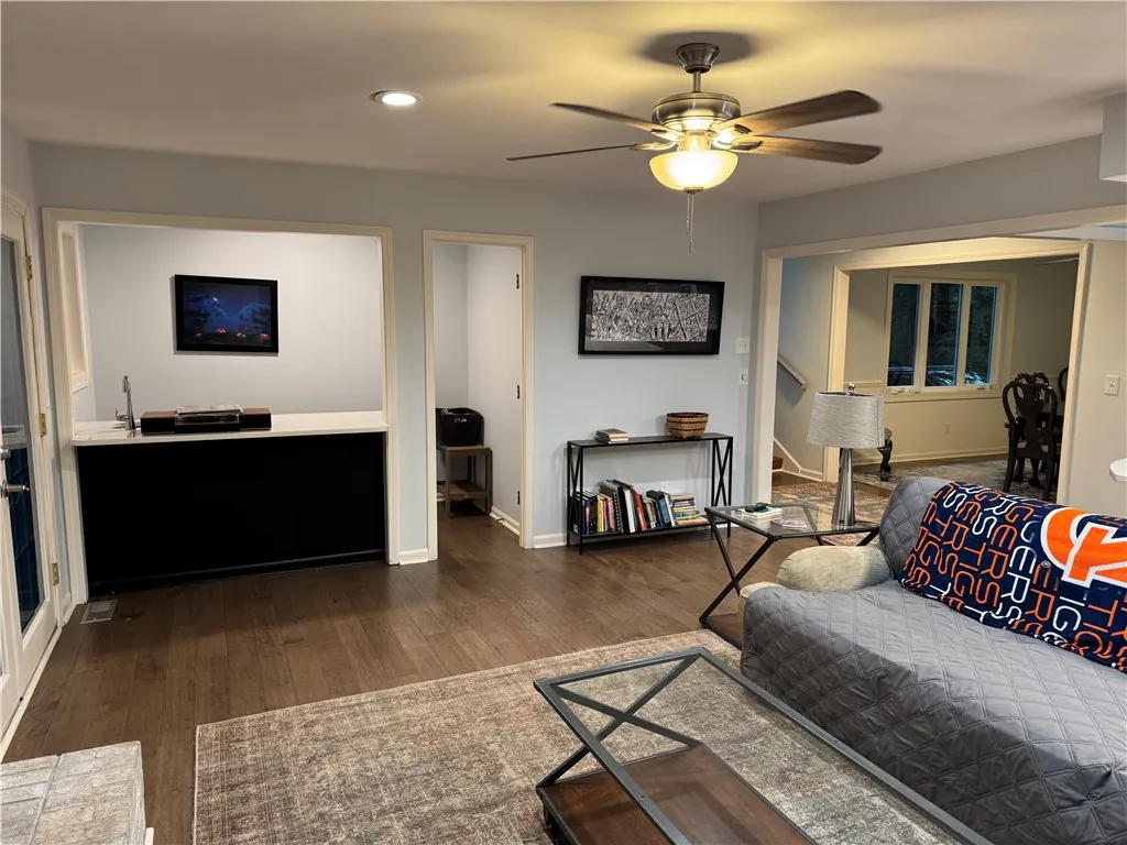 Hardwood floors and a wet bar create an inviting entertainment space.