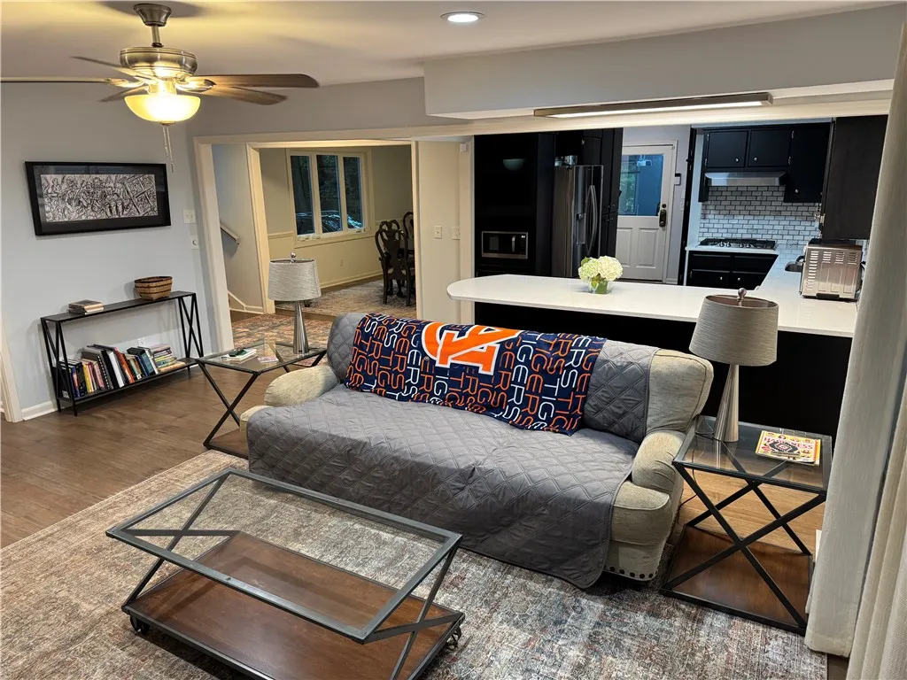 An inviting open-concept living area flows seamlessly into a well-appointed kitchen, ideal for modern living.