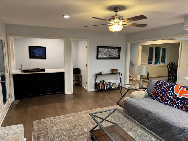 Hardwood floors and a wet bar create an inviting entertainment space.