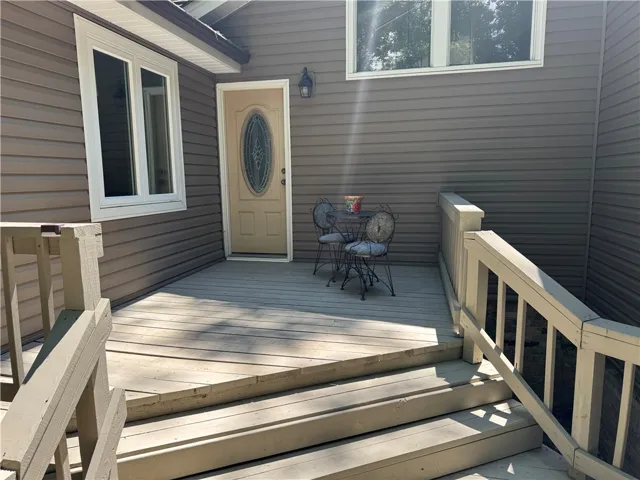 A well-maintained wooden deck extends from the structure, offering an inviting outdoor living space.