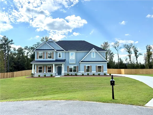 A classic two-story exterior features board and batten siding, decorative shutters, and stone accents.