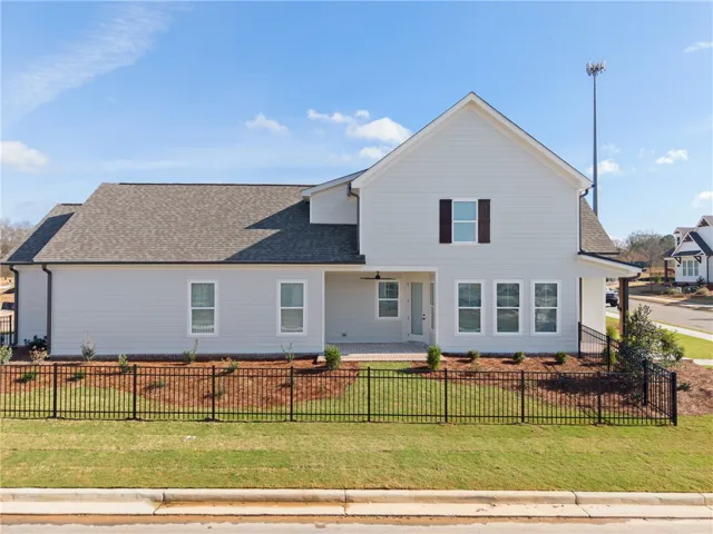 This inviting residence features a well-maintained exterior and a charming front porch.