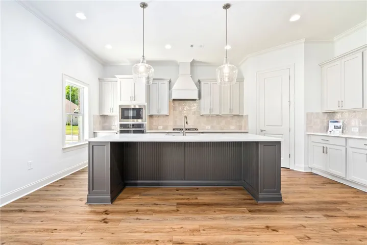 This bright kitchen features an expansive island and contemporary design.