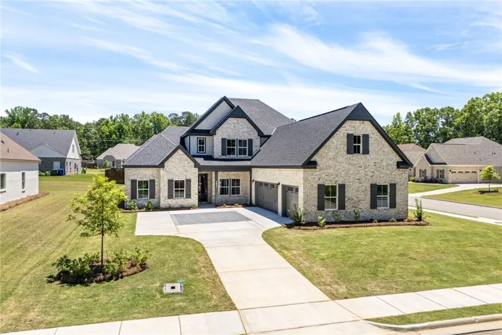 This modern home features a brick exterior and an attached garage, offering both curb appeal and functionality.