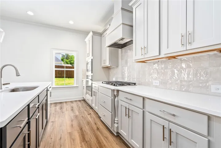 This modern kitchen features sleek countertops, stylish cabinetry, and durable flooring.