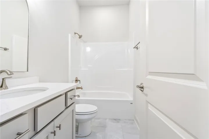 This bathroom features a sleek vanity, modern fixtures, and a clean, inviting atmosphere.