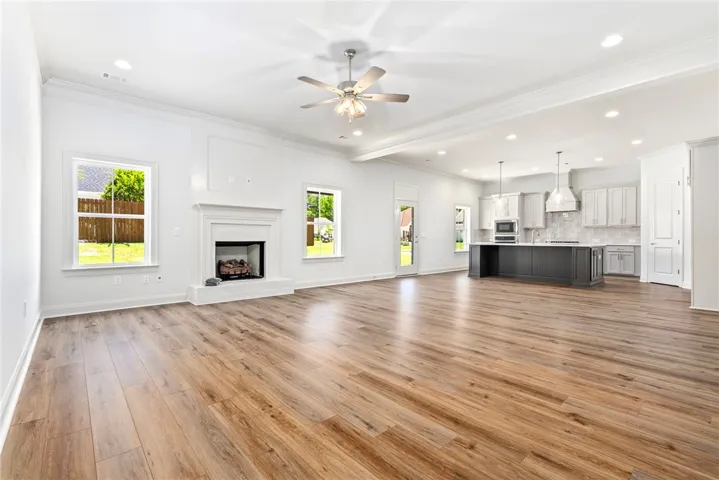 Bright and open-concept living space featuring sleek flooring and a contemporary kitchen.