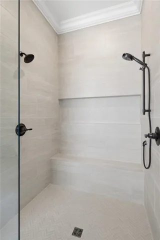 The zero-entry primary shower is gorgeous! A niche the width of the shower accommodates toiletries.