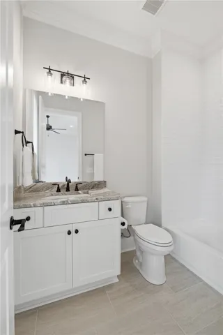 Bath 3 features a gorgeous granite counter and ceiling-height shower tile.