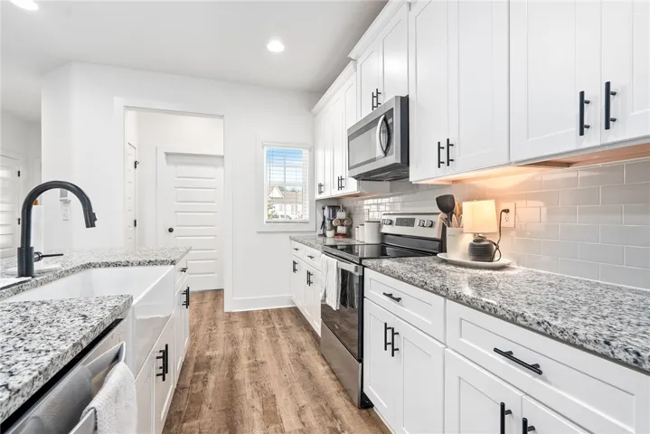 Kitchen features Whirlpool appliances and Delta Plumbing