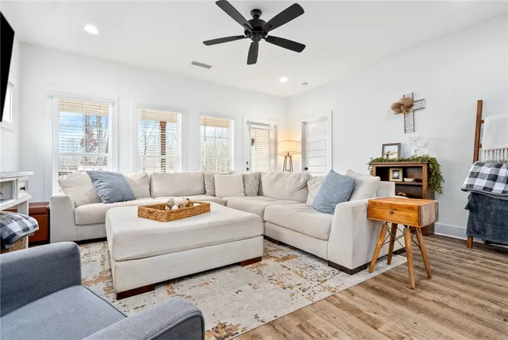 Spacious open concept living with large windows overlooking backyard