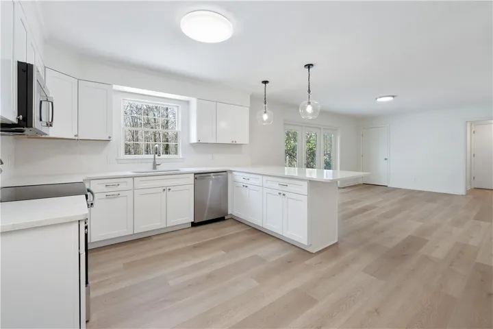 Kitchen updated with all new appliances, plumbing fixtures, cabinets, lighting & quartz countertops.