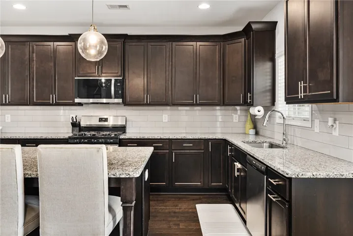The kitchen features an abundance cabinetry including specialty pullouts and drawers.