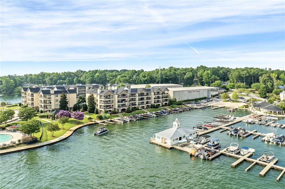 Discover a vibrant lakeside community featuring multi-story residences with private balconies overlooking a bustling marina.