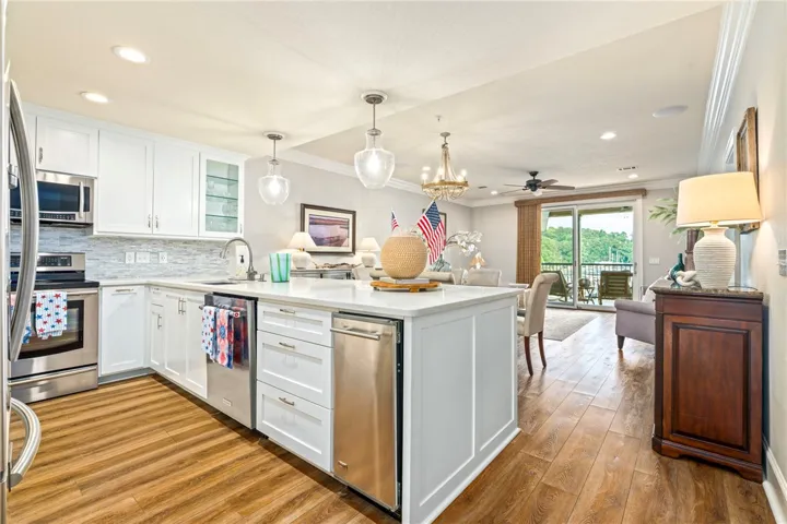 Prepare meals in a kitchen equipped with premium appliances and a generous island, flowing into an inviting living space.