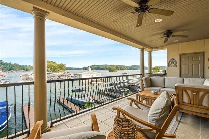 Lakeside veranda with columns offers captivating water views and ample space for open-air entertaining.