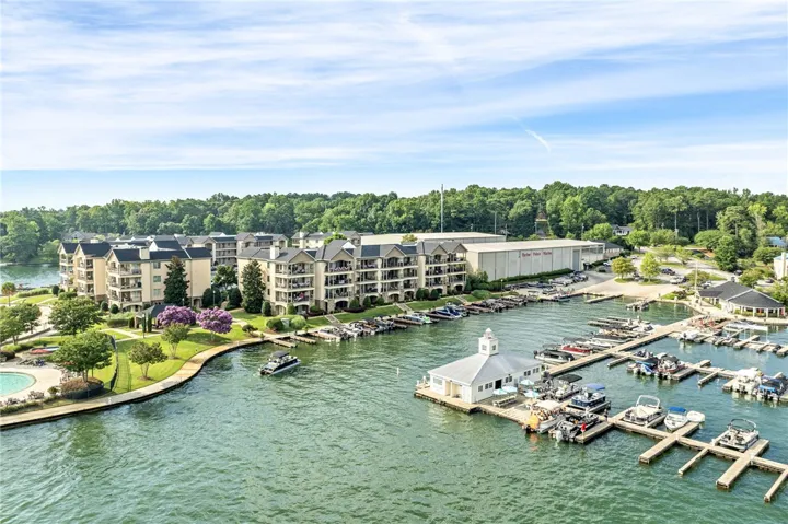 Discover a vibrant lakeside community featuring multi-story residences with private balconies overlooking a bustling marina.