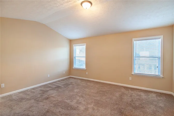Primary Bedroom w/ vaulted ceiling