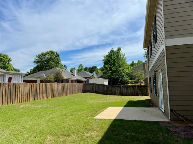 Enjoy the expansive private yard, perfect for outdoor living and entertaining, featuring a well-maintained lawn and privacy fencing.