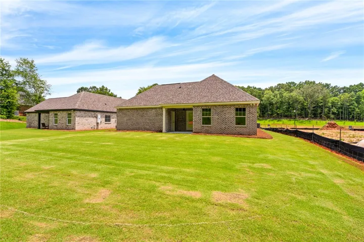 A verdant backyard offers ample space for outdoor enjoyment, ready for personalization.