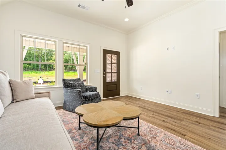A warm, inviting living space features wide plank flooring and ample natural illumination.