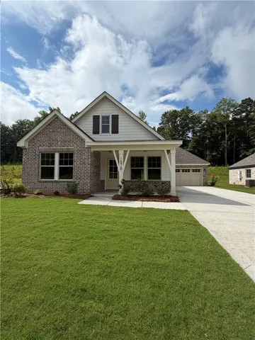 An inviting brick and siding facade with a welcoming covered porch awaits.