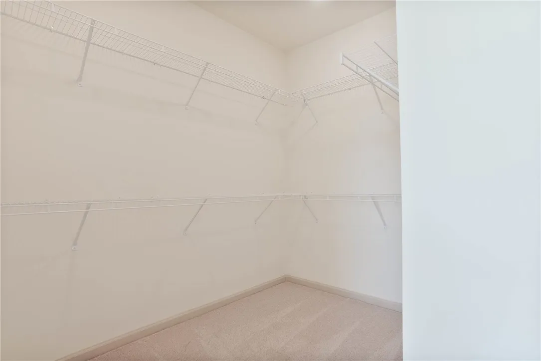 Well-organized closet with ample shelving awaits your personal touch.