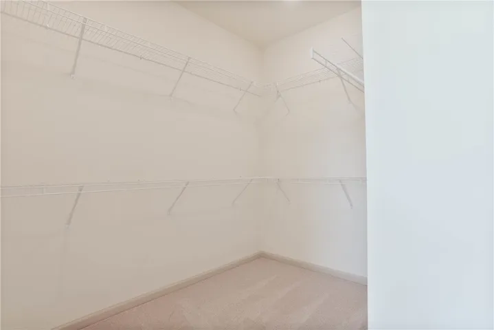 Well-organized closet with ample shelving awaits your personal touch.