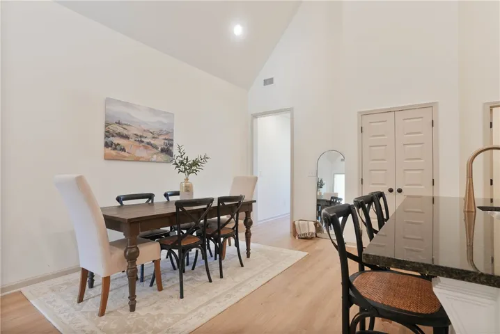 Vast vaulted ceilings complement the well-lit open-plan dining and kitchen areas.