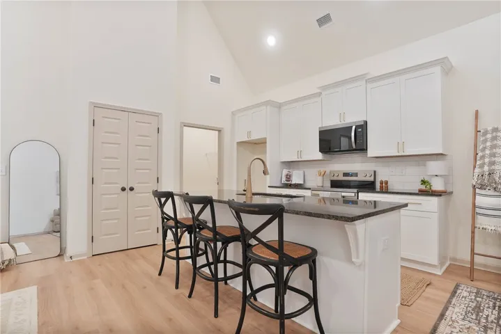 Culinary adventures await in this modern kitchen, boasting high ceilings and abundant prep space.