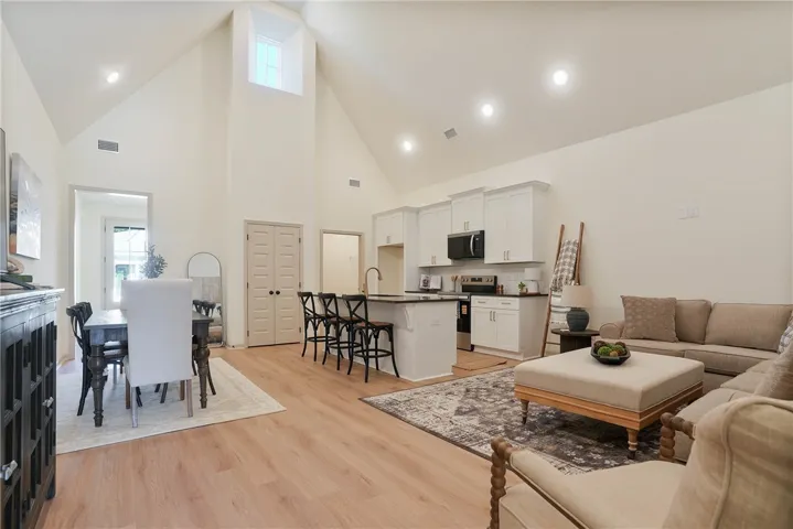 Soaring vaulted ceilings and abundant natural light define this expansive open-concept living space.