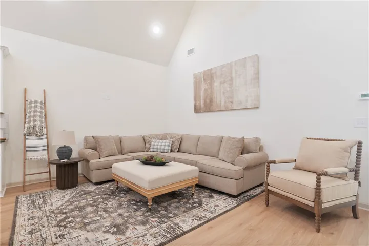 A welcoming living area showcases soaring vaulted ceilings and natural wood flooring, ideal for gatherings.