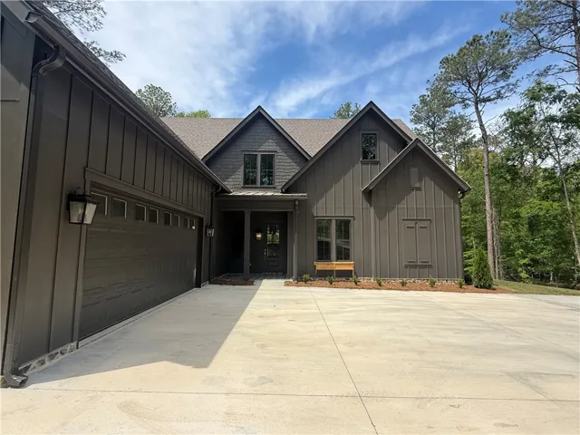 This charming home offers a perfect blend of modern comfort and natural serenity, featuring a welcoming entrance.