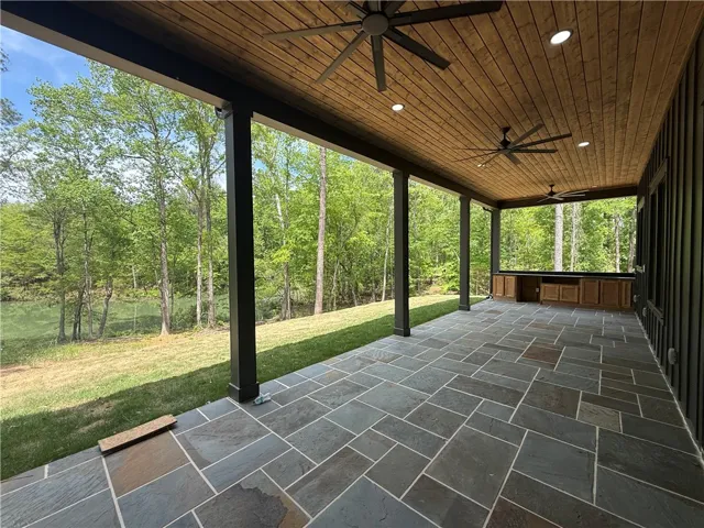Enjoy tranquil water and lush forest views from this expansive outdoor living space.