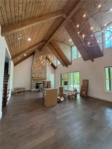 This expansive living space features vaulted ceilings and a grand stone fireplace.