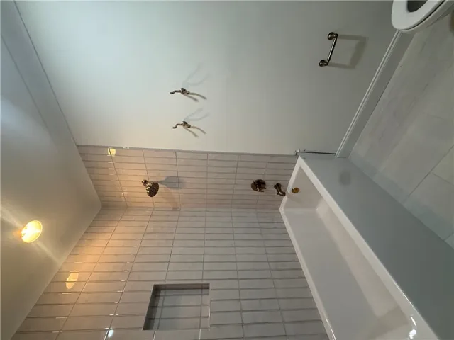 This bathroom features sleek tile work and contemporary fixtures.