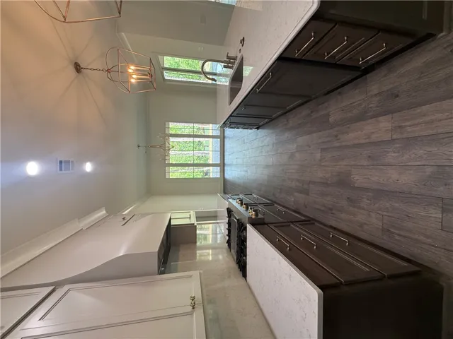 This spacious kitchen features sleek counters and durable flooring, perfect for daily living and entertaining.