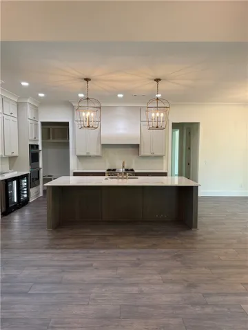 This spacious kitchen features an expansive island, ideal for gathering and culinary exploration.