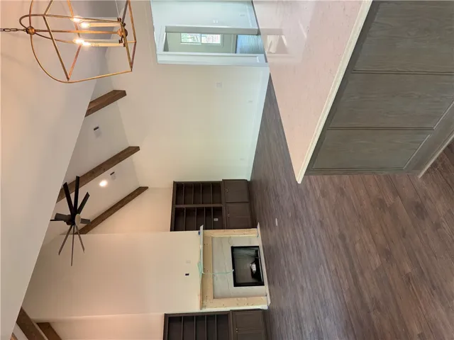 This grand living space features vaulted ceilings and rich wood flooring, perfect for gathering.