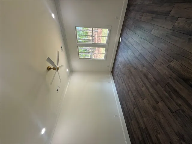 This bright space features sleek flooring and a classic ceiling fan, offering comfortable living.
