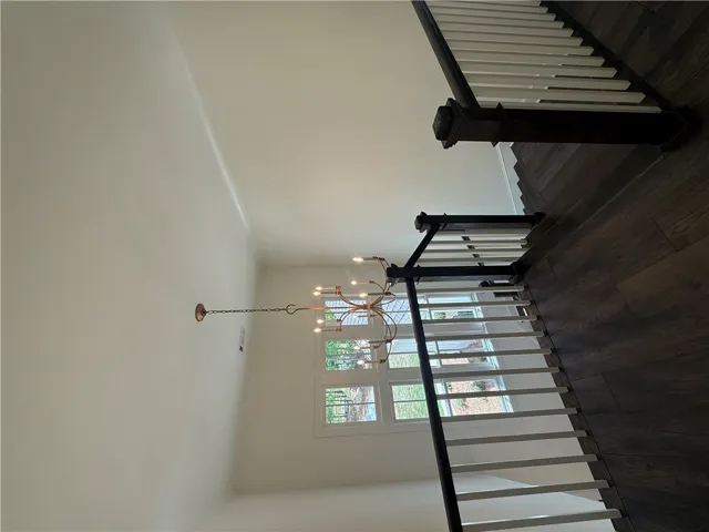 Elegant staircase with rich hardwood flooring welcomes you.