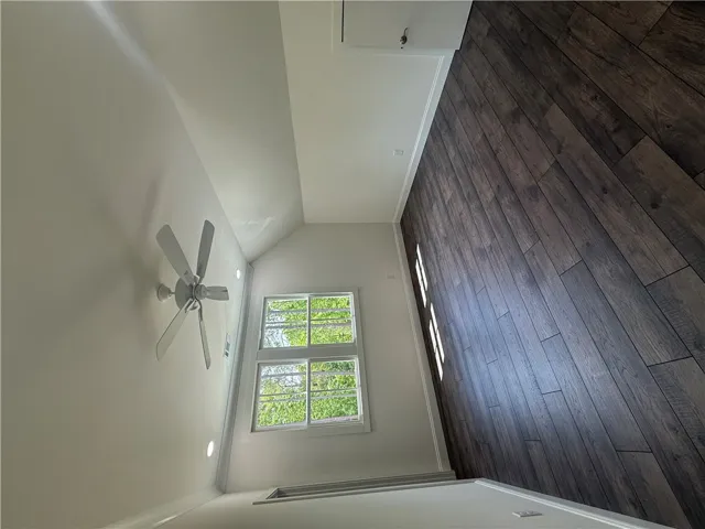 This airy room features rich wood flooring and abundant natural light.