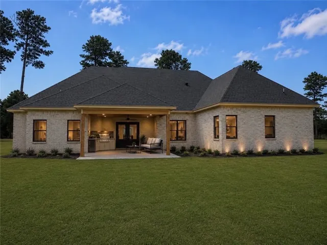 A refined outdoor living space features an impressive built-in barbecue station and covered patio.