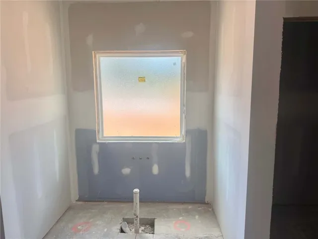 A well-placed window illuminates this evolving bathroom space, awaiting its final touches.