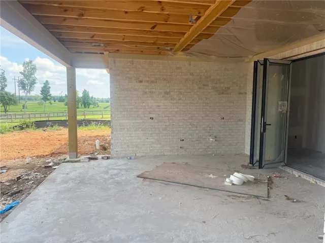 A spacious covered patio offers pastoral views, ready for your outdoor living designs.