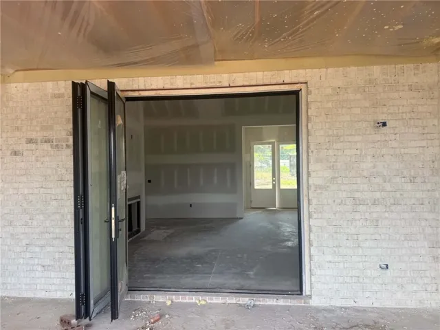 An inviting entry with expansive bi-fold doors offers seamless indoor-outdoor living.