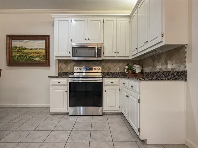 This bright kitchen features ample cabinetry and modern appliances, perfect for everyday living.