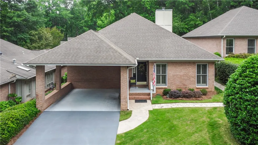 This classic brick residence features a welcoming entrance and a convenient carport.