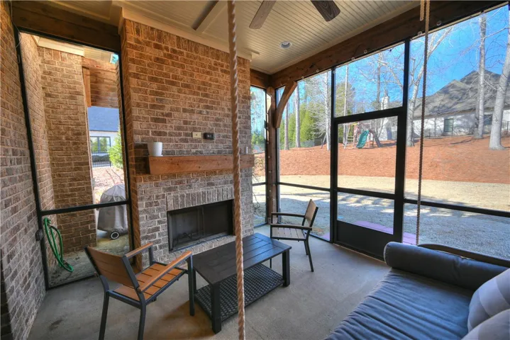 The covered and screened back porch is finished with a woodburning fireplace.