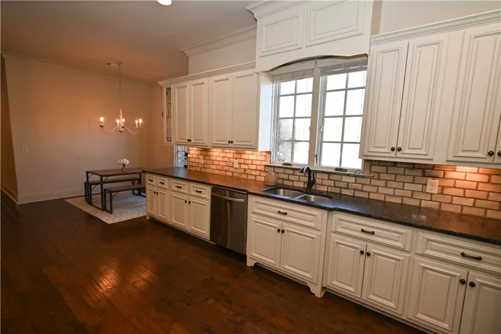 Tiled backsplash and recessed walk-in pantry.